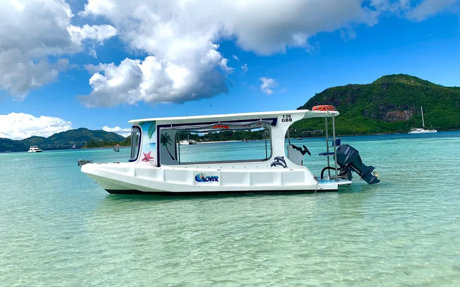 A glass-bottom boat moored off a Seychelles island